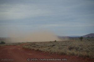 Truck throwing up a bit of dust on the road near Lake Gairdner