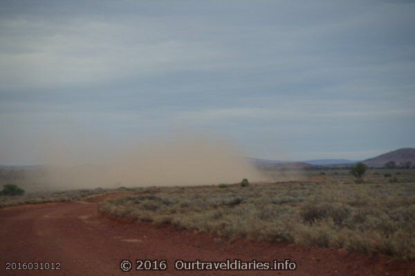 Truck throwing up a bit of dust on the road near Lake Gairdner